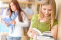 Teenage student read book at high school library Royalty Free Stock Photo