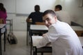 Teenage student sitting in a classroom. Looking at camera Royalty Free Stock Photo