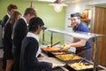 Teenage Students Being Served Meal In School Canteen Royalty Free Stock Photo