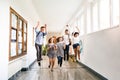 Teenage students in high school hall jumping high. Royalty Free Stock Photo