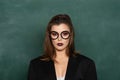 Teenage students with school books. Blonde woman in front of chalkboard. Ready for study. Sensual female student Royalty Free Stock Photo