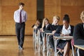 Teenage Students Sitting Examination With Teacher Invigilating Royalty Free Stock Photo