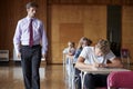 Teenage Students Sitting Examination With Teacher Invigilating Royalty Free Stock Photo
