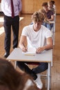 Teenage Students Sitting Examination With Teacher Invigilating Royalty Free Stock Photo