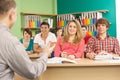 Teenage Students Studying In Classroom With Tutor