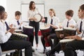 Teenage Students Studying Percussion In Music Class