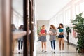 Teenage students walking in high school hall during break. Royalty Free Stock Photo