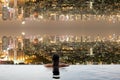 Teenage in swimming pool with city upside down Royalty Free Stock Photo