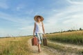 Teenage traveler walking along on country road