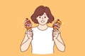 Teenage woman holds two ice creams with fruit syrup and waffle cone and looks at screen smiling Royalty Free Stock Photo