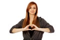 Teenage woman making heart shape with her hands