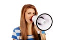 Teenage woman screaming through megaphone Royalty Free Stock Photo