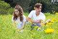 A teenage young couple having fun in a field of chrysanthemum