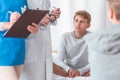 Young patient is sitting cross-legged on a hospital bed during hospitalization