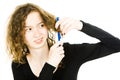 Teenaged blond girl with hair having tangled hair dressing problem - combing curly hair Royalty Free Stock Photo