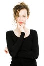 Teenaged girl in black dress posing in studio on white background