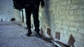 Teenager in abandoned house, comfortable shoes for extreme adventures closeup