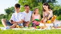 Teenager absorbed of phone during family picnic