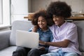 Teenager African couple sit on sofa using wireless computer Royalty Free Stock Photo