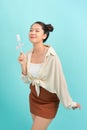 Teenager asian girl holding a lollipop over isolated blue background Royalty Free Stock Photo