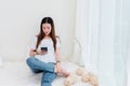Teenager asian girl using smartphone on bed Royalty Free Stock Photo