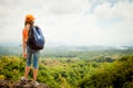 Teenager with a backpack standing on a mountain top Royalty Free Stock Photo