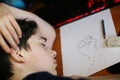 Teenager boy art school student sleep on his homework drawing Royalty Free Stock Photo