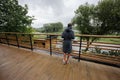 Teenager boy in bath robe stand in wooden terrace of modern house Royalty Free Stock Photo