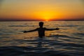 Teenager boy bathing on a beach at sunset in Sicily Royalty Free Stock Photo