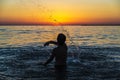 Teenager boy bathing in the sea at sunset in Sicily Royalty Free Stock Photo