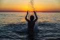 Teenager boy bathing in the sea at sunset in Sicily Royalty Free Stock Photo