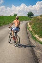 Teenager boy on bicycle on the road outside the city in nature Royalty Free Stock Photo