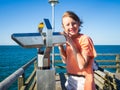 Teenager boy with binocular on a pier Royalty Free Stock Photo