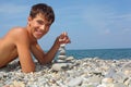 Teenager boy creates pyramid from pebble