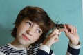 Teenager boy cut his hair with scissors Royalty Free Stock Photo