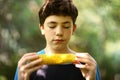 Teenager boy eating boiled corn cob close up photo Royalty Free Stock Photo