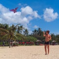 Teenager boy flying a kite on tropical beach Royalty Free Stock Photo