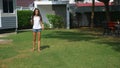 A teenager boy and girl play badminton on a green lawn in the backyard of their home Royalty Free Stock Photo