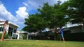 A teenager boy and girl play badminton on a green lawn in the backyard of their home Royalty Free Stock Photo