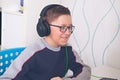 Teenager boy in glasses looking at computer monitor Royalty Free Stock Photo