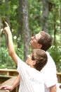 Teenager boy and his father hiking in summer park Royalty Free Stock Photo