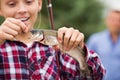 Teenager boy looking at fish on hook Royalty Free Stock Photo