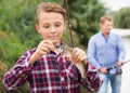 Teenager boy looking at fish on hook Royalty Free Stock Photo