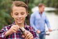 Teenager boy looking at fish on hook Royalty Free Stock Photo