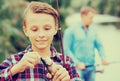 Teenager boy looking at fish on hook Royalty Free Stock Photo