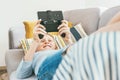 Teenager boy lying on the cozy sofa and enthusiastically plays