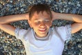 Teenager boy lying on stones, closed eyes Royalty Free Stock Photo