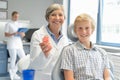 Teenager boy patient dentist hold teeth dentures