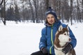 Teenager boy plaing with white Husky dog in winter day Royalty Free Stock Photo