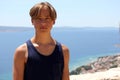 Teenager boy portrait by the sea in summer. Royalty Free Stock Photo